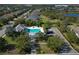 Aerial view of the community pool and parking, surrounded by residences and tropical landscaping at 4623 Claremont Park Dr, Lakewood Ranch, FL 34211