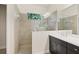 Tiled shower stall with glass partition, view of a garden window, and dual shower heads at 4623 Claremont Park Dr, Lakewood Ranch, FL 34211