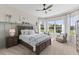 Bright bedroom featuring hardwood floors, large windows, and nature views at 4735 Trento Pl, Bradenton, FL 34211