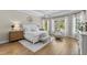 Serene bedroom with natural light, wood floors, and a cozy seating area at 4735 Trento Pl, Bradenton, FL 34211