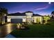 Charming single-Gathering home displaying manicured lawn and elegant front facade and garden, with brick driveway at 4735 Trento Pl, Bradenton, FL 34211