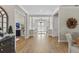 Inviting foyer with wood flooring, columns, and a view of the double front doors at 4735 Trento Pl, Bradenton, FL 34211