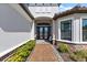 Elegant entryway with a brick path, decorative double doors, and manicured bushes at 4735 Trento Pl, Bradenton, FL 34211