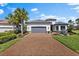 Charming home with well-manicured landscaping, a brick driveway, and a two-car garage at 4735 Trento Pl, Bradenton, FL 34211