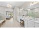 Bright main bathroom featuring double vanity, large mirror, and ensuite access to main bedroom at 4735 Trento Pl, Bradenton, FL 34211