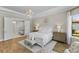 Bright main bedroom featuring hardwood floors, neutral color palette, chandelier, and ensuite access at 4735 Trento Pl, Bradenton, FL 34211