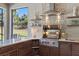 Elegant outdoor kitchen featuring a built-in grill, counter space, and decorative backsplash at 4735 Trento Pl, Bradenton, FL 34211