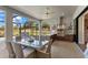Covered patio with dining area and fully-equipped outdoor kitchen overlooking the backyard at 4735 Trento Pl, Bradenton, FL 34211