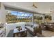 Covered patio with comfortable seating, dining area, and a beautiful view of the pool at 4735 Trento Pl, Bradenton, FL 34211