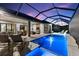 Private screened pool area with modern furniture, outdoor dining, and views of the twilight sky at 4735 Trento Pl, Bradenton, FL 34211