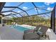 Inviting pool with screened-in enclosure and comfortable lounge chairs, nestled amongst lush greenery at 4735 Trento Pl, Bradenton, FL 34211