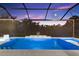 Relaxing pool with serene views, water feature and elegant stone accents, perfect for unwinding at 4735 Trento Pl, Bradenton, FL 34211