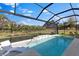 Sparkling pool with inviting chaise lounge and lush palm trees, surrounded by a screened-in enclosure at 4735 Trento Pl, Bradenton, FL 34211