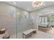 Bright bathroom featuring a large glass enclosed shower and ensuite access to the main bedroom at 4735 Trento Pl, Bradenton, FL 34211