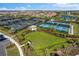 Several community tennis courts surrounded by lush landscaping and nearby parking areas at 4735 Trento Pl, Bradenton, FL 34211