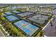 Aerial view of tennis and pickleball courts and lush landscaping at 4735 Trento Pl, Bradenton, FL 34211