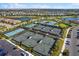 Overhead view of multiple tennis courts with well-maintained landscaping and parking at 4735 Trento Pl, Bradenton, FL 34211