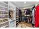 Spacious walk-in closet featuring hardwood floors, custom shelving, and ample storage space at 4735 Trento Pl, Bradenton, FL 34211