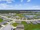 Aerial view of the community showcases homes surrounding a picturesque lake, providing serene waterfront living at 4918 Gray Owl Ter, Palmetto, FL 34221
