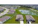 Aerial view of a neighborhood with green spaces, and a pond at 4918 Gray Owl Ter, Palmetto, FL 34221