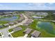Expansive aerial view of a residential community featuring homes, ponds, and manicured lawns at 4918 Gray Owl Ter, Palmetto, FL 34221