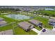 Aerial view showcasing neighborhood homes, a tranquil pond, and well-manicured green spaces at 4918 Gray Owl Ter, Palmetto, FL 34221