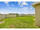 Expansive backyard with green lawn, white privacy fence, and tranquil water view at 4918 Gray Owl Ter, Palmetto, FL 34221