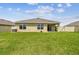 Spacious backyard with green lawn and fence, adjacent houses visible at 4918 Gray Owl Ter, Palmetto, FL 34221