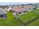 Spacious backyard with lush green grass and a charming fence, perfect for outdoor entertaining at 4918 Gray Owl Ter, Palmetto, FL 34221