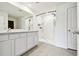 A bathroom features double sinks and a walk-in shower at 4918 Gray Owl Ter, Palmetto, FL 34221