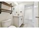 Modern bathroom features a large mirror, floating shelves and white shaker cabinets at 4918 Gray Owl Ter, Palmetto, FL 34221