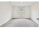 A bright bedroom features plush gray carpeting and a single window at 4918 Gray Owl Ter, Palmetto, FL 34221