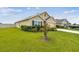 Well-maintained home exterior with green lawn, flowering plants and neutral color scheme at 4918 Gray Owl Ter, Palmetto, FL 34221