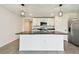 Contemporary kitchen with white cabinetry, granite island and stainless steel appliances at 4918 Gray Owl Ter, Palmetto, FL 34221