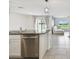 Bright kitchen features stainless steel appliances, granite countertops, and open layout to the living room at 4918 Gray Owl Ter, Palmetto, FL 34221