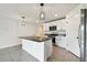 A kitchen with granite countertops, a kitchen island, and stainless steel appliances at 4918 Gray Owl Ter, Palmetto, FL 34221
