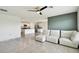 Open living room with tiled floors that blends the living area and kitchen seamlessly at 4918 Gray Owl Ter, Palmetto, FL 34221