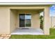 Covered patio with stucco columns and view of the backyard and fence at 4918 Gray Owl Ter, Palmetto, FL 34221