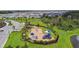 Aerial view of the community playground that has modern play equipment and lush green surroundings at 4918 Gray Owl Ter, Palmetto, FL 34221