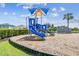 Community playground with blue slides, climbing structures, and a wood chip ground cover at 4918 Gray Owl Ter, Palmetto, FL 34221