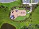 Overhead view of a guitar shaped playground with slides, swings, and benches, nestled in a lush green landscaped area at 4918 Gray Owl Ter, Palmetto, FL 34221