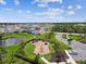 Aerial view of a community playground with modern equipment, lush landscaping, and surrounding neighborhood homes at 4918 Gray Owl Ter, Palmetto, FL 34221
