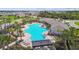 Resort-style community pool featuring a spacious layout, luxurious lounge chairs, covered seating, and lush landscaping at 4918 Gray Owl Ter, Palmetto, FL 34221
