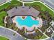 Aerial view of a community pool with inviting lounge area, sun-soaked deck, and meticulously maintained grounds at 4918 Gray Owl Ter, Palmetto, FL 34221