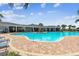 Inviting community pool showcasing a well-maintained deck, comfortable lounge chairs, and covered seating areas at 4918 Gray Owl Ter, Palmetto, FL 34221