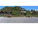 Relaxing beach scene with lush greenery, a lifeguard tower, and people enjoying the sunny weather at 503 Albee Farm Rd # B6, Venice, FL 34285