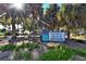 Venice Beach community sign surrounded by lush tropical landscaping with picnic benches in the background at 503 Albee Farm Rd # B6, Venice, FL 34285