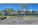 Charming condo with a well-maintained lawn and mature palm trees on a bright sunny day at 503 Albee Farm Rd # B6, Venice, FL 34285