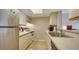 Efficient kitchen featuring white appliances, light countertops, and ample cabinet storage, creating a functional cooking space at 503 Albee Farm Rd # B6, Venice, FL 34285