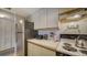 Compact kitchen with bright countertops, essential appliances, and ample storage solutions for efficient meal preparation at 503 Albee Farm Rd # B6, Venice, FL 34285